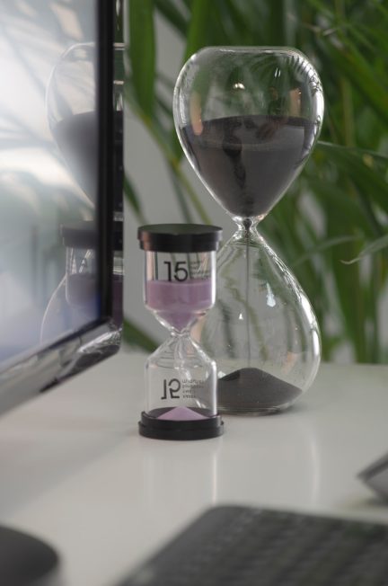 clear hour glass on white table