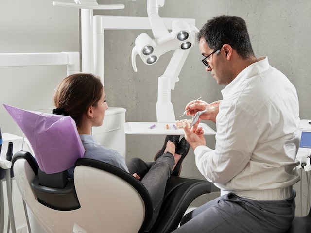 man in white shirt sitting on black office rolling chair