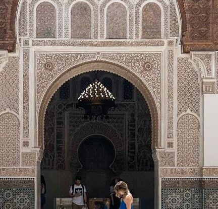 Travel With Kids - A woman in blue dress standing in front of a fountain