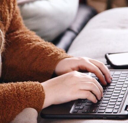 Special Education - Woman in Brown Sweater Using Laptop Computer