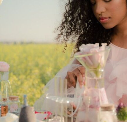 Standardized Testing - Young Woman in Airy Summer Dress Creating Perfumes in Flower Field Laboratory