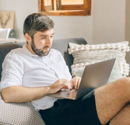 Home Office - A Man Using a Laptop