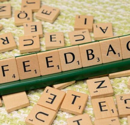 Customer Feedback - The word feedback is spelled out with scrabble tiles