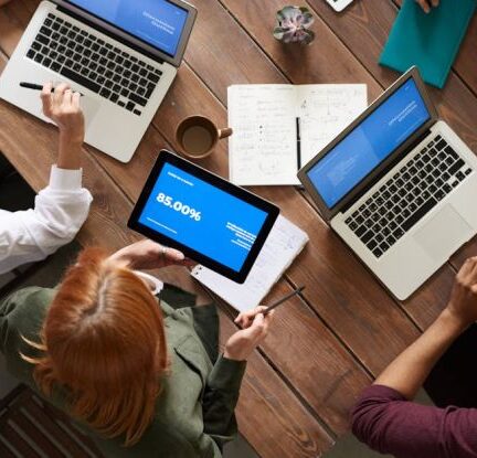 Employees - Top View Photo of Group of People Using Macbook While Discussing