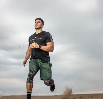 Exercise - Man Running on Sand Field