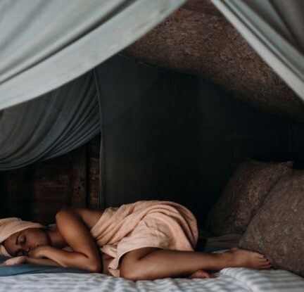 Sleep - Woman Lying on Bed wrapped around a Towel