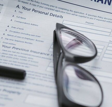 Insurance Policy - Black Framed Eyeglasses on White Paper