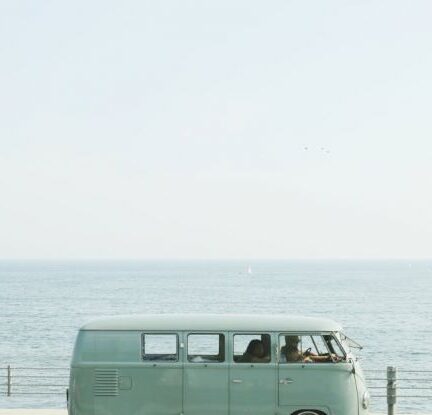 Autonomous Driving - Van Parked Beside the Road Near Handrail and Ocean