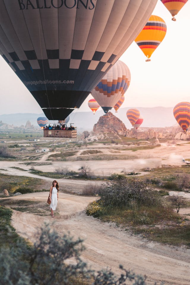 woman-standing-under-hot-air-balloons